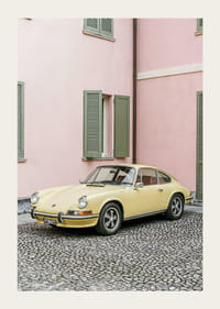 A charming pastel yellow Porsche 911 in front of a pink wall gives a retro feel.-3