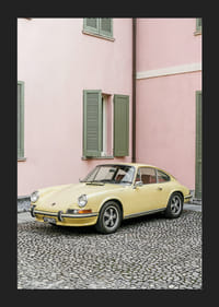 A charming pastel yellow Porsche 911 in front of a pink wall gives a retro feel.-5