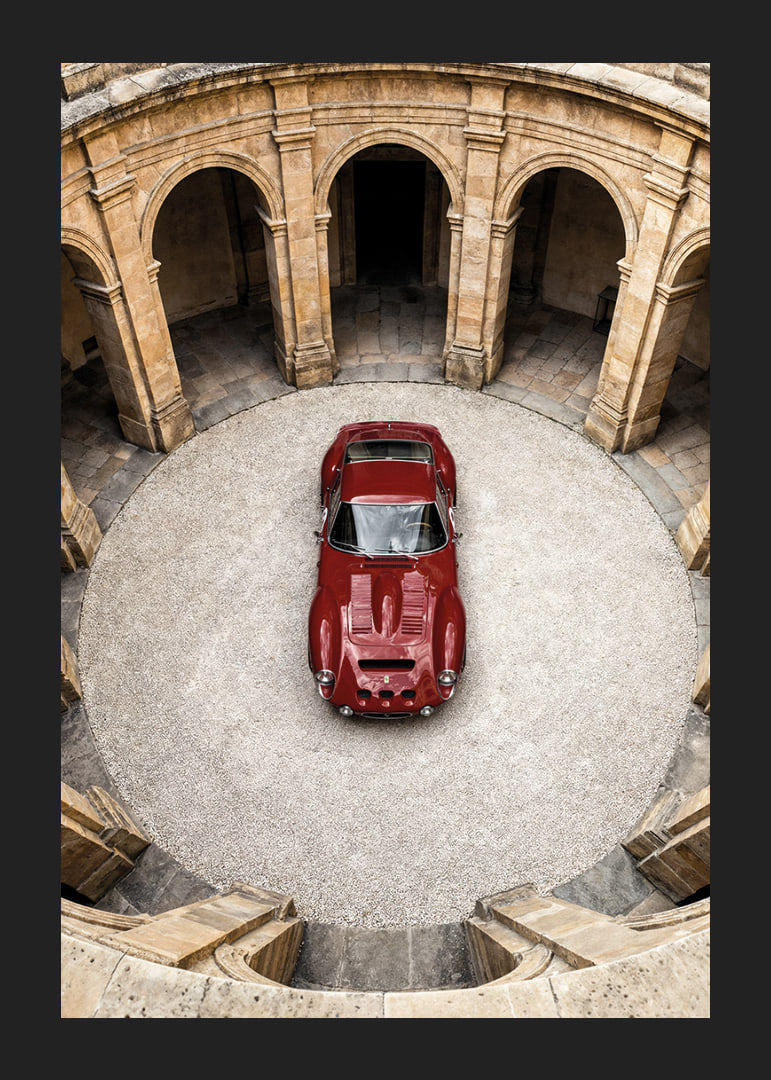 A red classic Ferrari 250 GTO in a majestic courtyard.-12