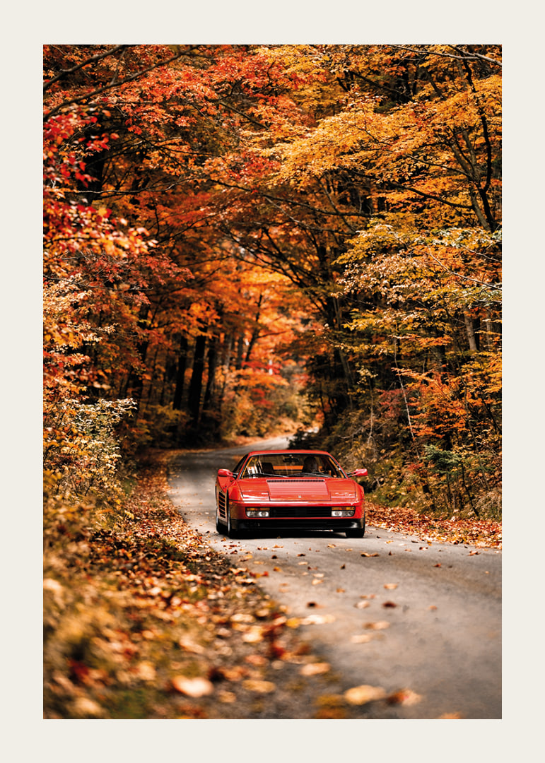 A red Ferrari Testarossa is surrounded by the glowing colors of autumn.-12