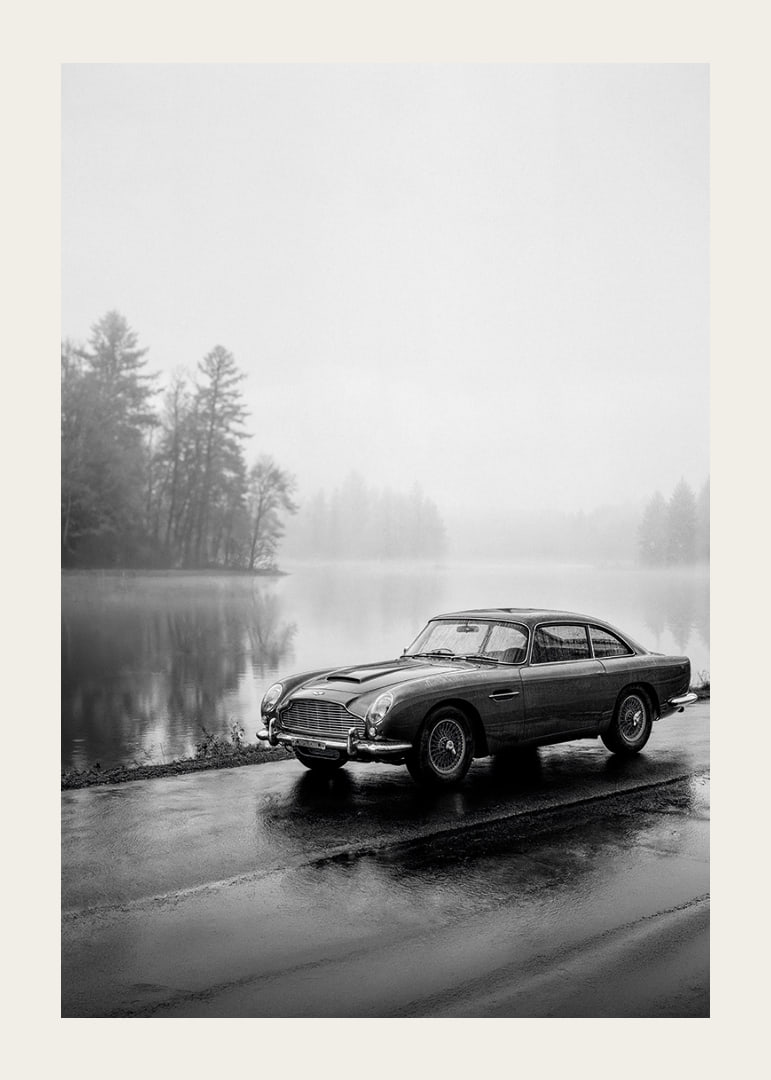 A classic Aston Martin DB5 by a foggy seaway exudes calm and nostalgia.-12