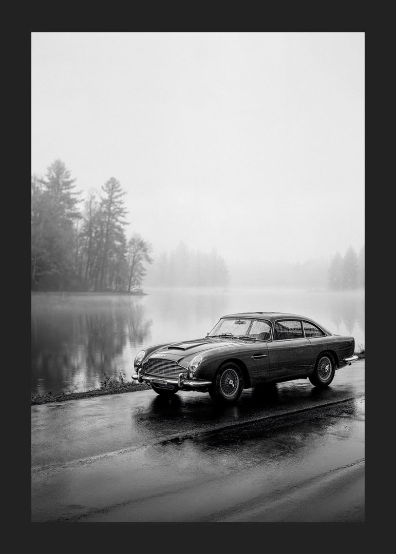 A classic Aston Martin DB5 by a foggy seaway exudes calm and nostalgia.-12