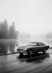 A classic Aston Martin DB5 by a foggy seaway exudes calm and nostalgia.-7
