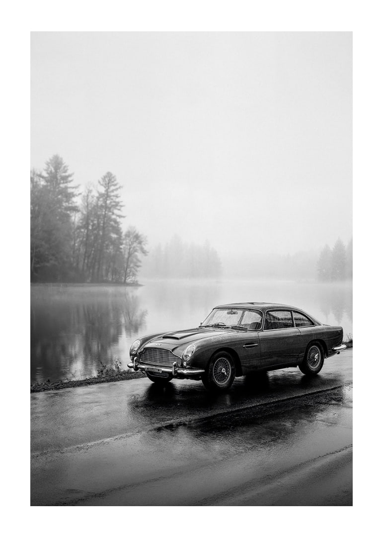 A classic Aston Martin DB5 by a foggy seaway exudes calm and nostalgia.-12