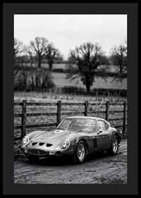 En klassisk Ferrari 250 GTO står ståtlig på en grusväg omgiven av träd.-4