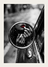 Raindrops on the mirror embrace a moment of seductive beauty.-3