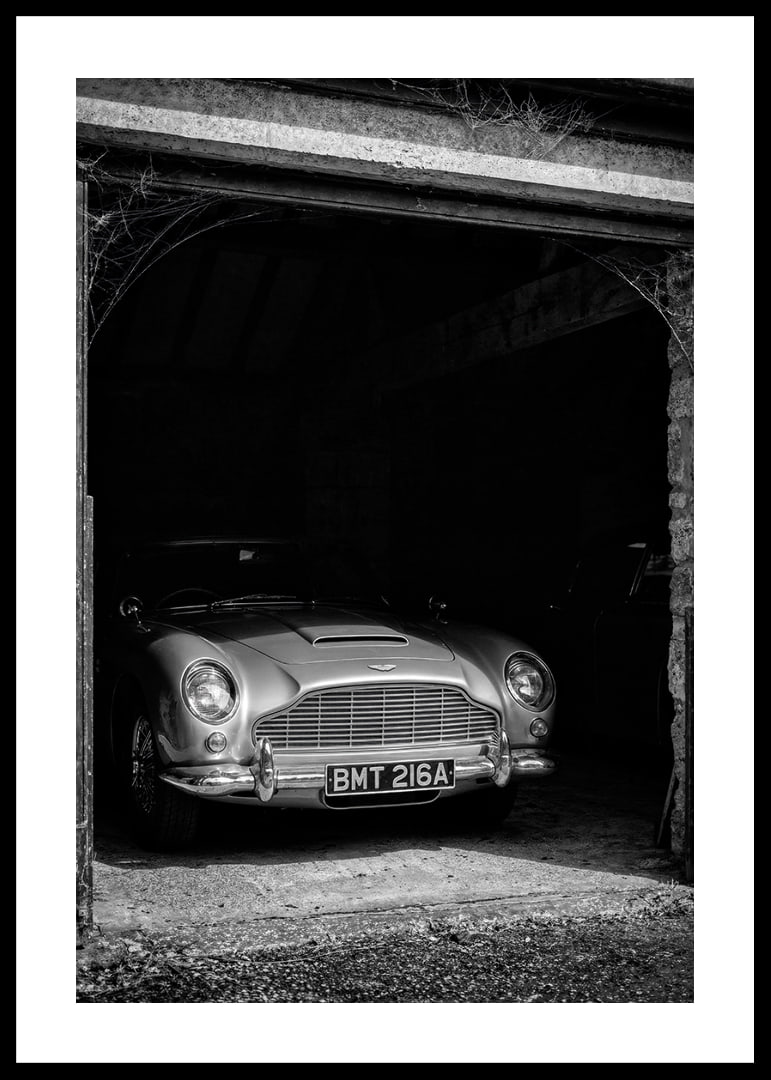 A classic Aston Martin DB5 proudly parked in a nostalgic garage.-12
