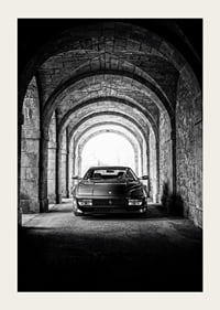 En klassisk Ferrari Testarossa genom en stentäckt valvpassage.-3