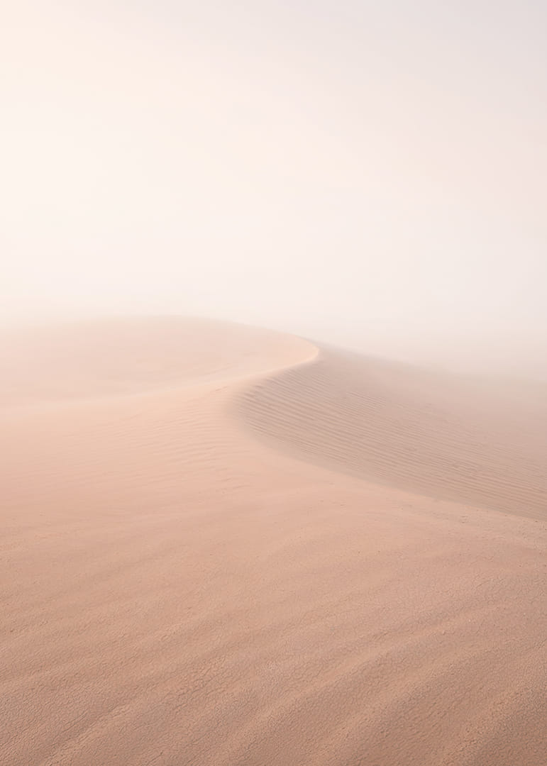 Soft pink sand dunes in a dreamlike desert horizon.-12
