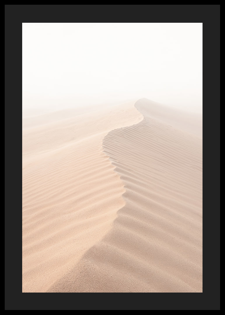 A soft wave of sand sweeps through a desolate landscape.-12