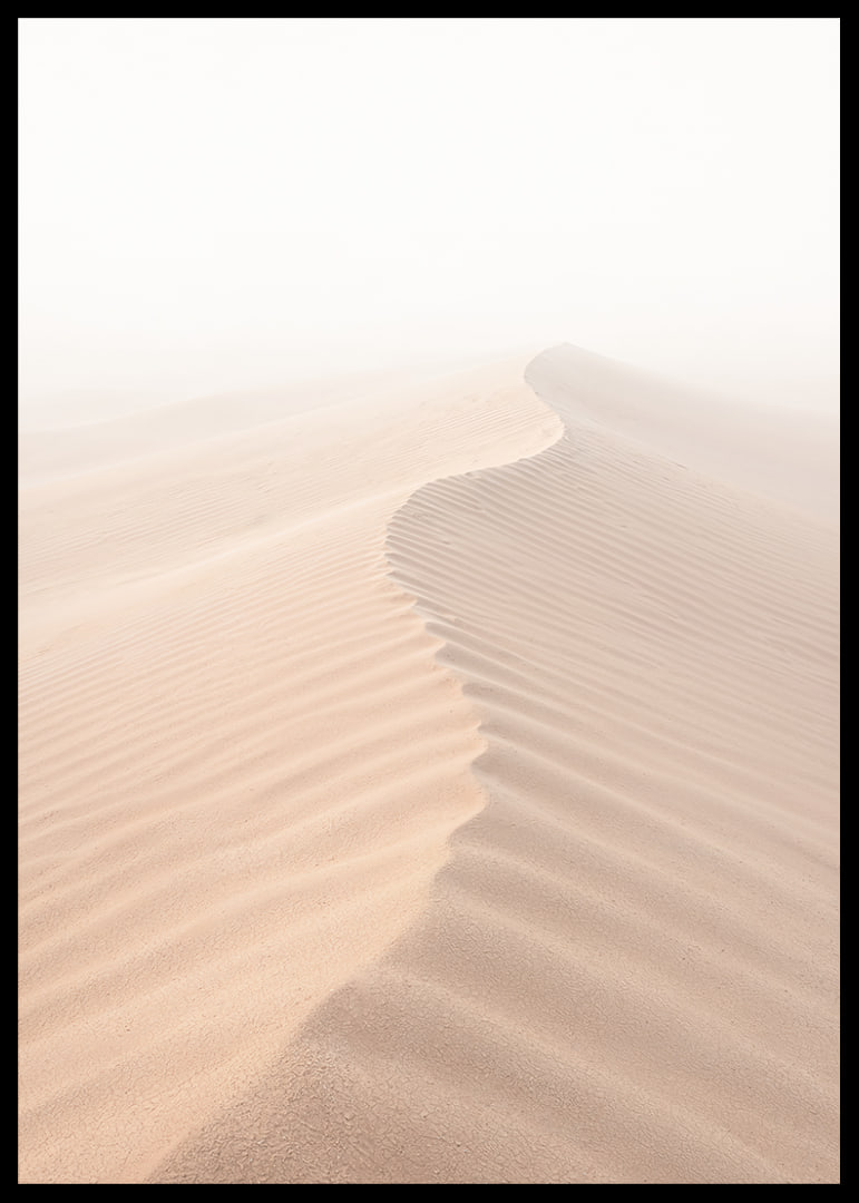 A soft wave of sand sweeps through a desolate landscape.-12