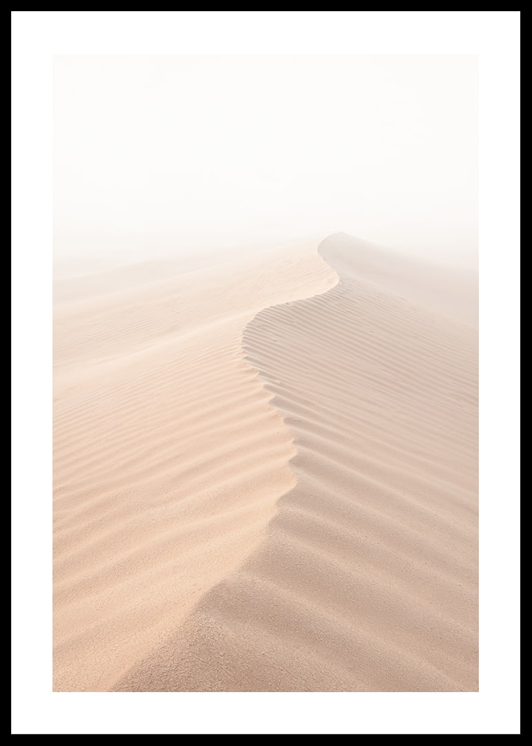 A soft wave of sand sweeps through a desolate landscape.-12