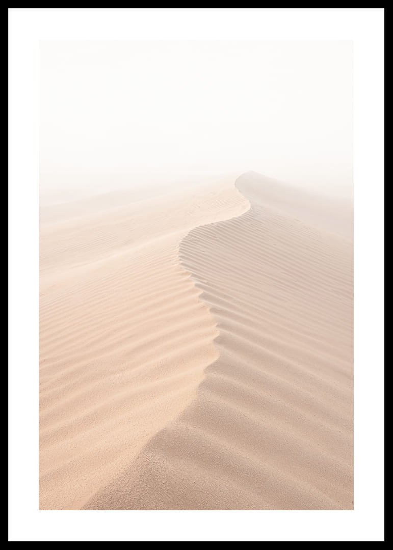 A soft wave of sand sweeps through a desolate landscape.-12
