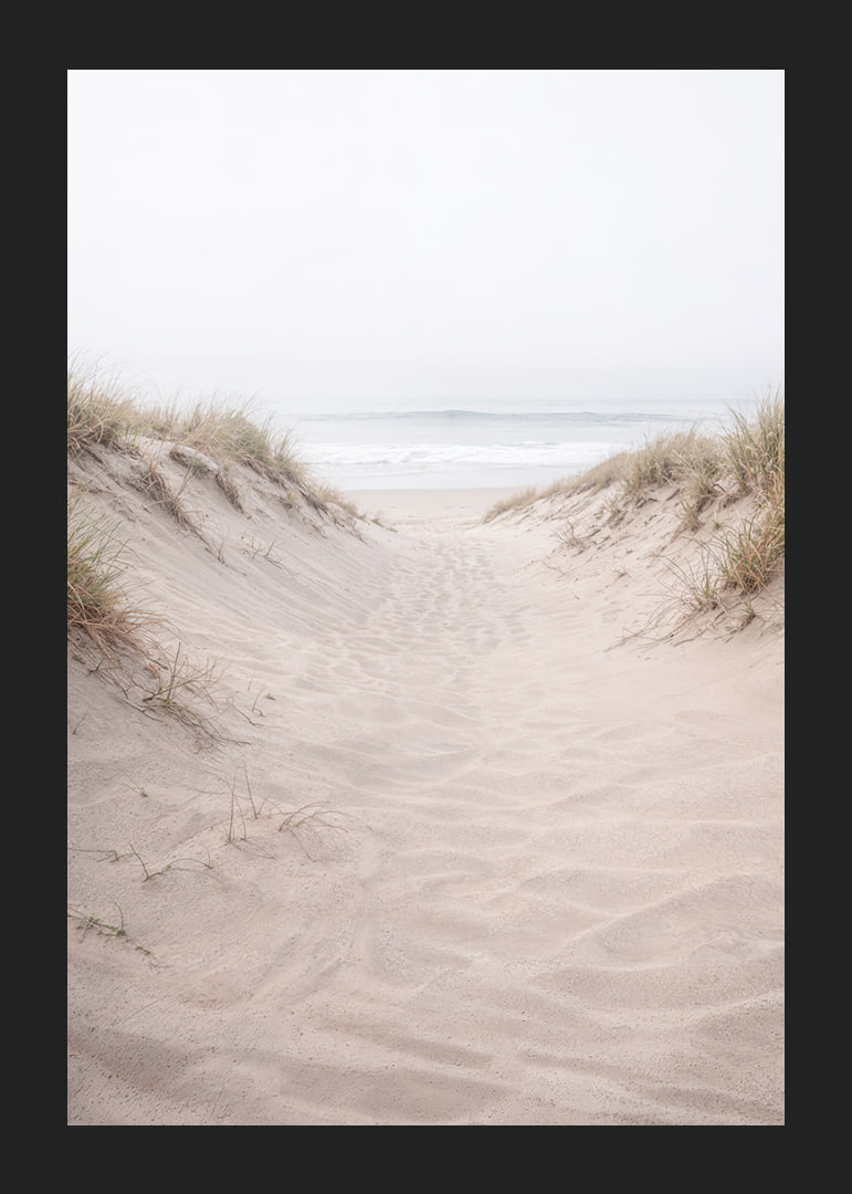 Soft sand leads towards the distant horizon of the sea.-12