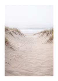 Soft sand leads towards the distant horizon of the sea.-1