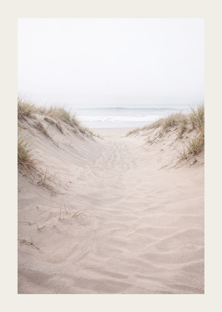 Soft sand leads towards the distant horizon of the sea.-12