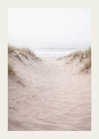 Soft sand leads towards the distant horizon of the sea.-3