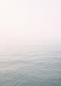 Calm sea view meets bright sky in fog.-7