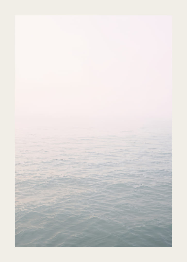 Calm sea view meets bright sky in fog.-12