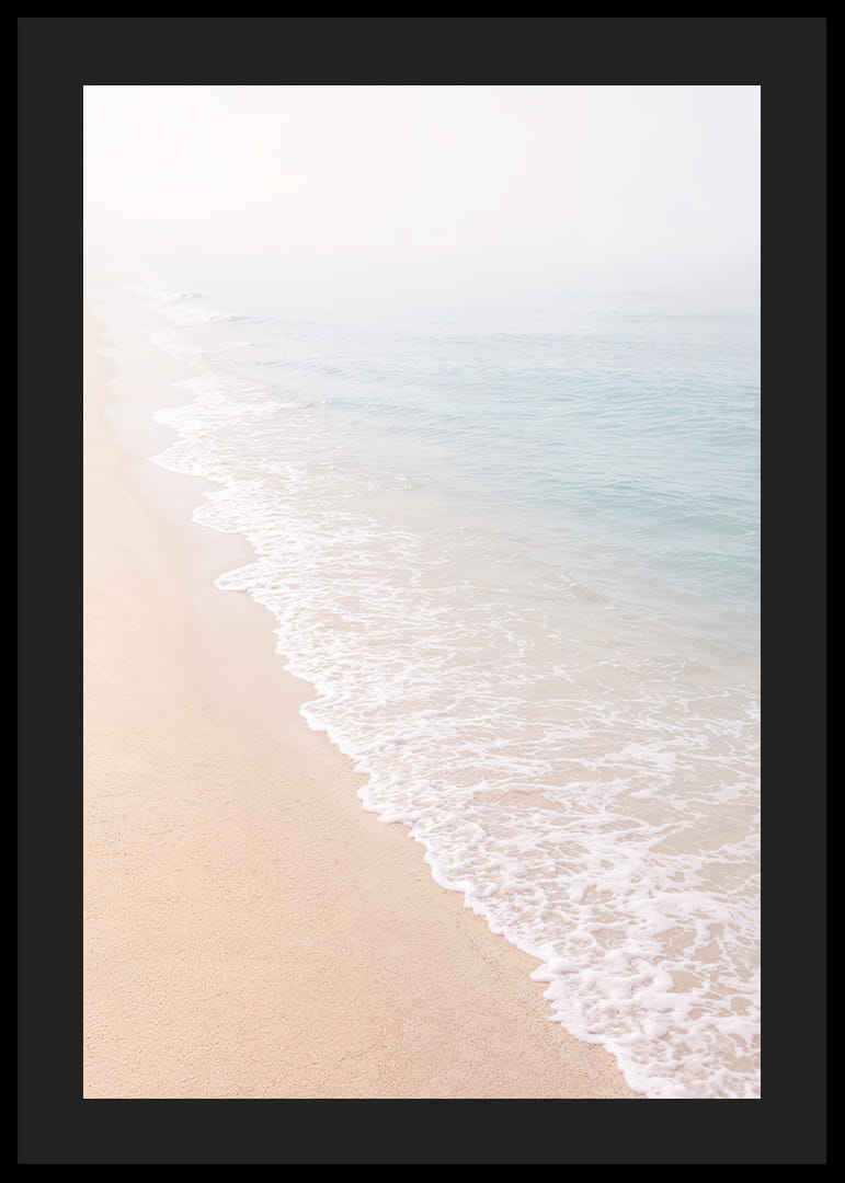 Gentle waves roll in towards the misty coast.-12