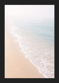 Gentle waves roll in towards the misty coast.-5