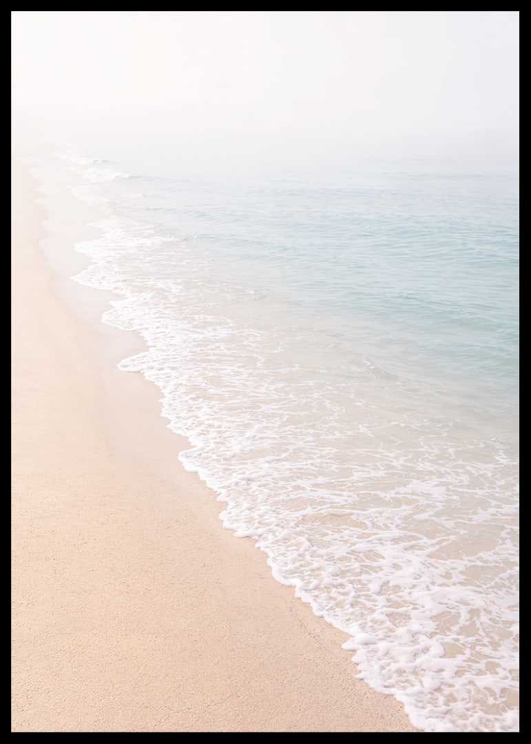 Gentle waves roll in towards the misty coast.-12
