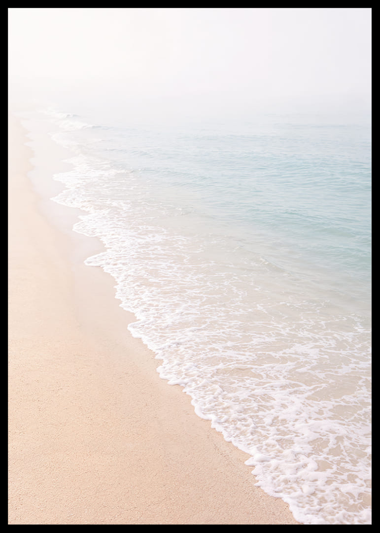 Gentle waves roll in towards the misty coast.-12