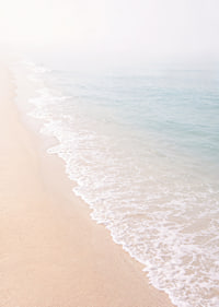 Gentle waves roll in towards the misty coast.-7