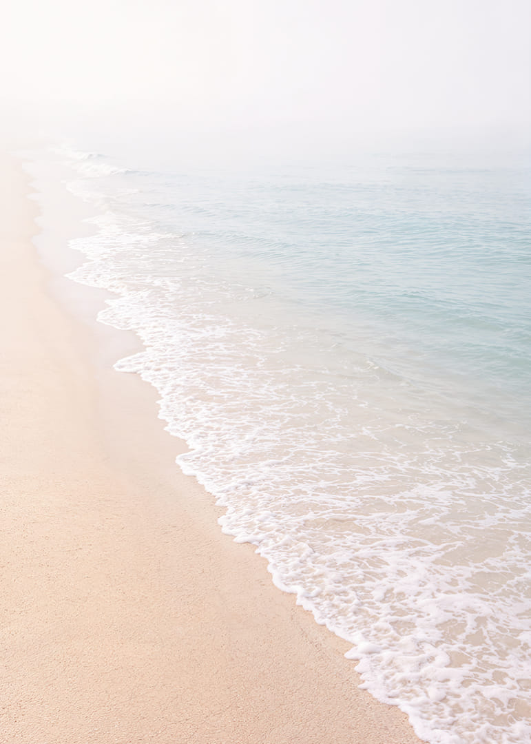 Gentle waves roll in towards the misty coast.-12