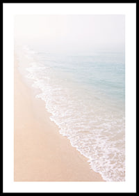 Gentle waves roll in towards the misty coast.-0