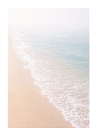 Gentle waves roll in towards the misty coast.-1