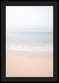 A misty coast where the sea meets the sand in soft tones.-4