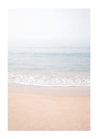 A misty coast where the sea meets the sand in soft tones.-1