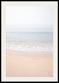 A misty coast where the sea meets the sand in soft tones.-2