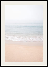 A misty coast where the sea meets the sand in soft tones.-2