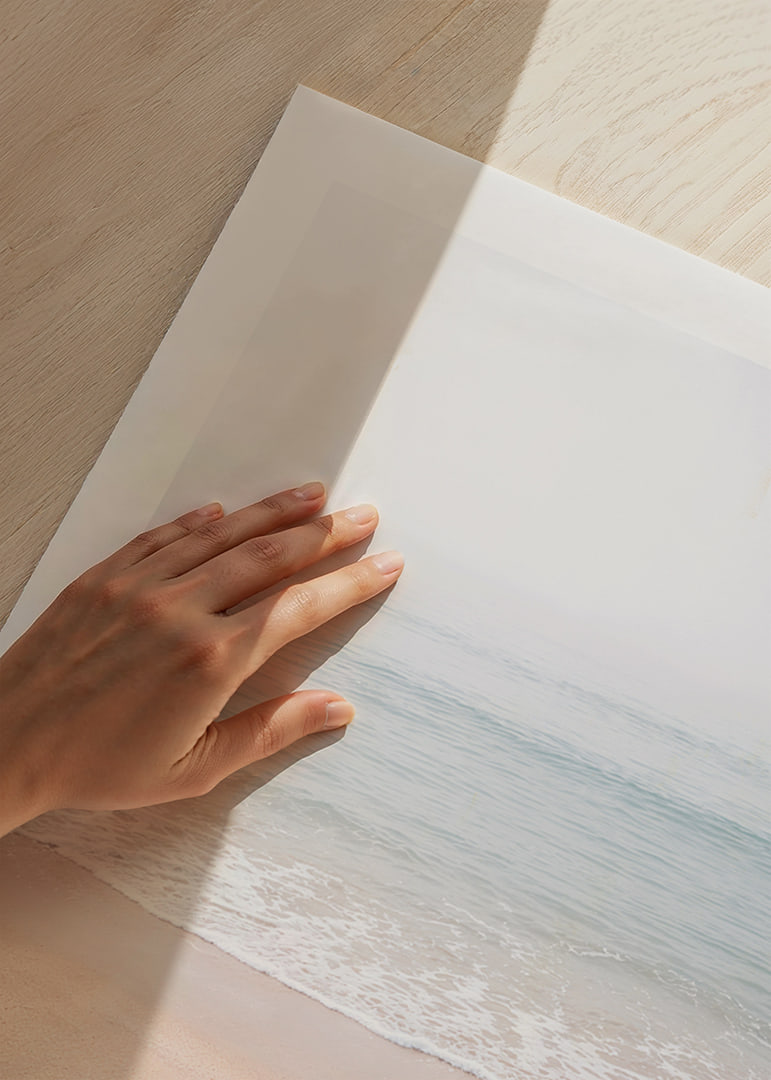 A misty coast where the sea meets the sand in soft tones.-12
