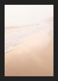 A warm, soft beach in a misty haze creates peace and tranquility.-5