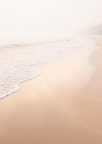 A warm, soft beach in a misty haze creates peace and tranquility.-7