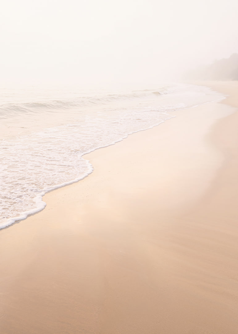 A warm, soft beach in a misty haze creates peace and tranquility.-12