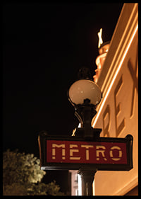 Classic French metro sign in the city's warm night light-6