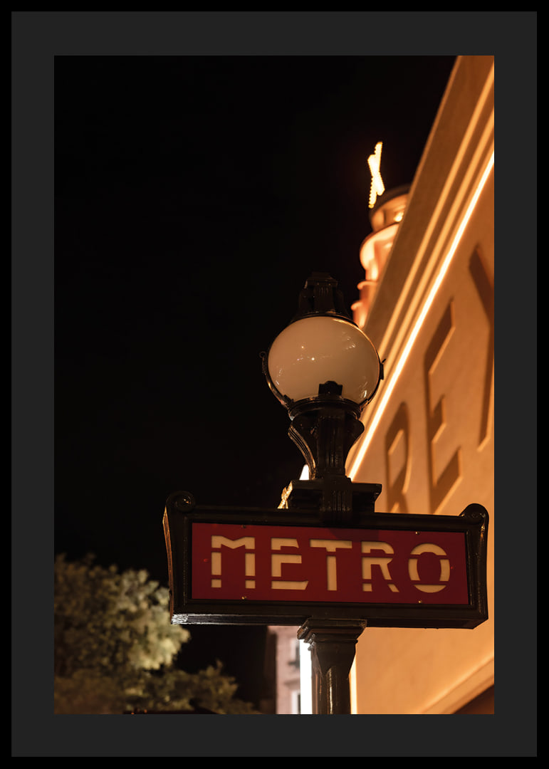 Classic French metro sign in the city's warm night light-12