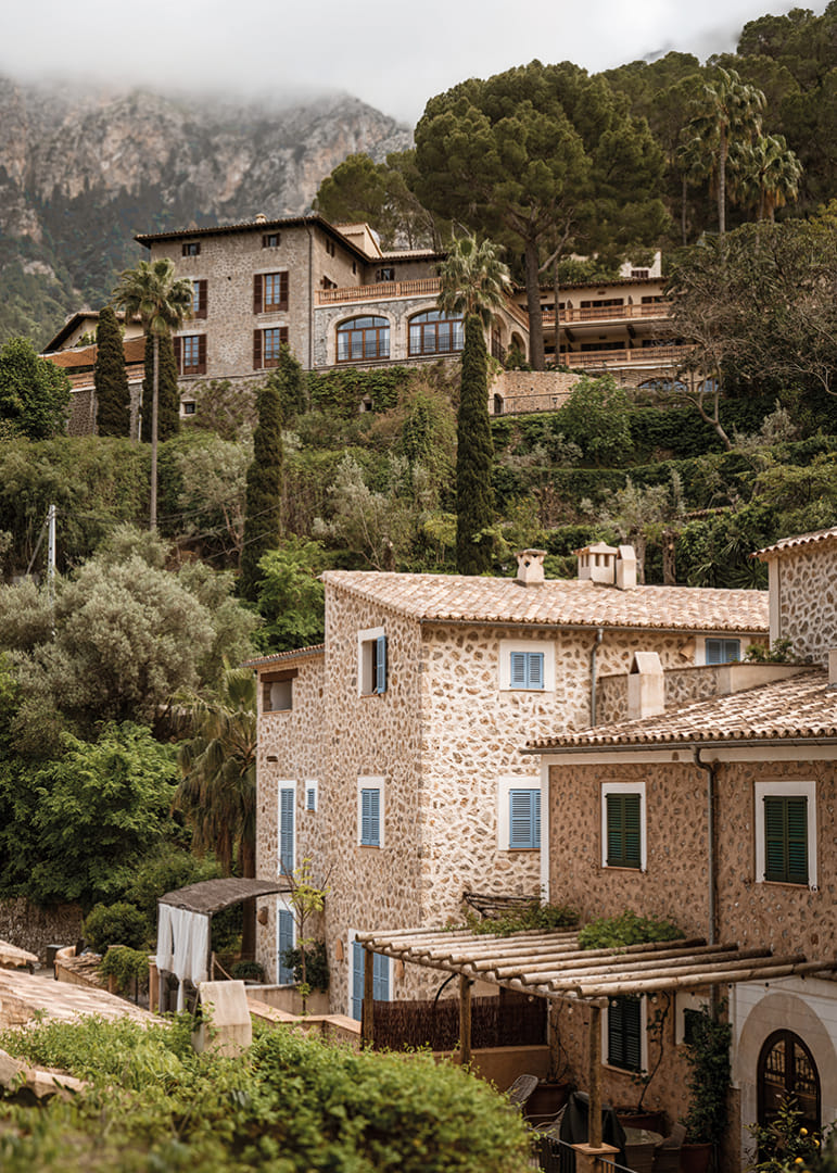 Charming village with stone houses surrounded by lush greenery.-12