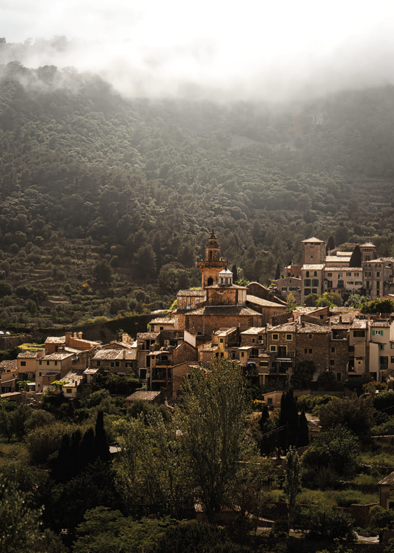 A village nestled in the silent embrace of the misty mountains.-12