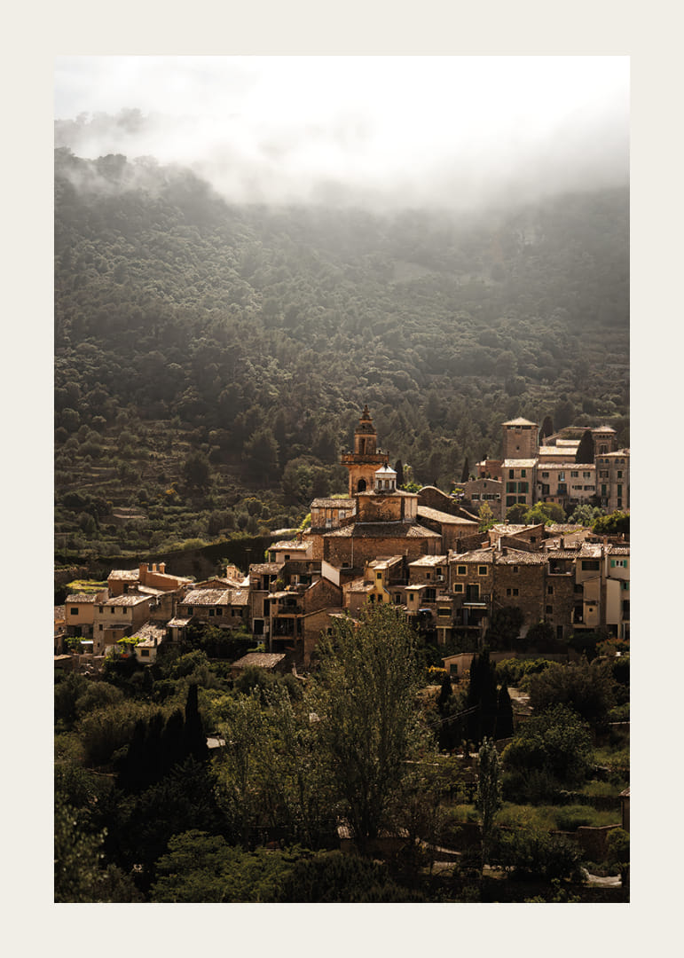 A village nestled in the silent embrace of the misty mountains.-12