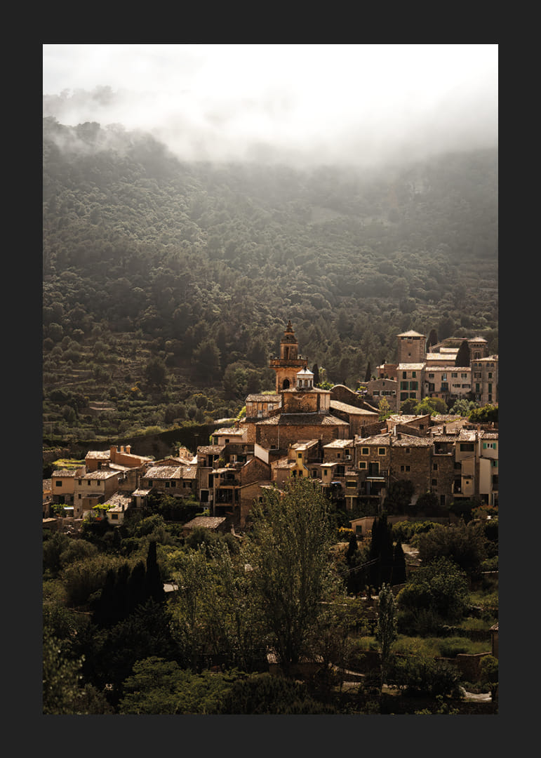 A village nestled in the silent embrace of the misty mountains.-12