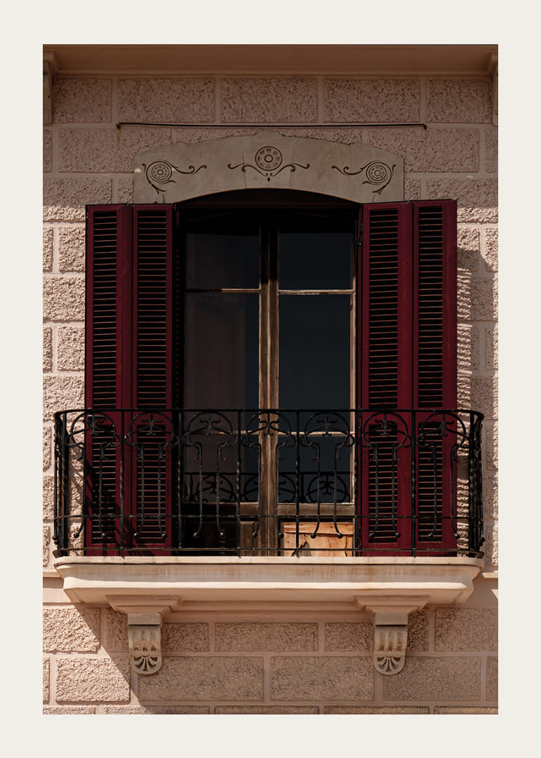 An elegant balcony with rustic red shutters.-12