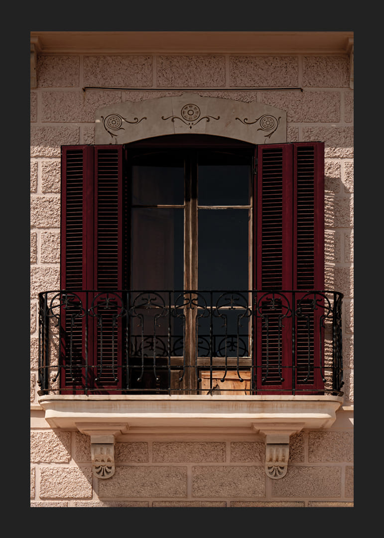 An elegant balcony with rustic red shutters.-12
