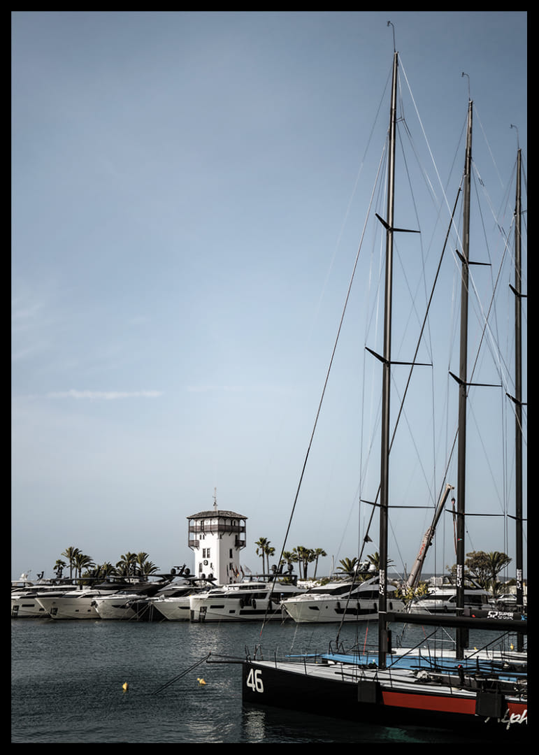 A quiet harbor with elegant masts against a clear sky.-12