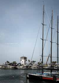 A quiet harbor with elegant masts against a clear sky.-7