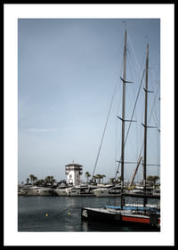 A quiet harbor with elegant masts against a clear sky.-0